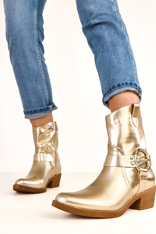 Bottes de cowboy dorées à talon avec... Bottes de cowboy dorées à talon avec...