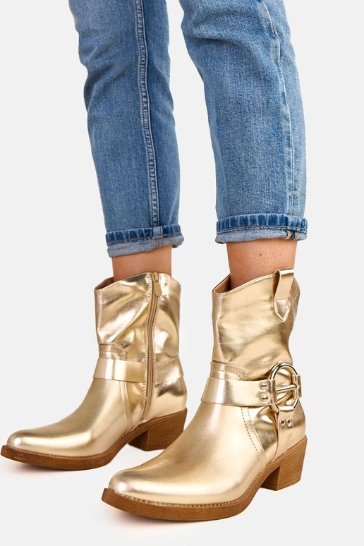 Bottes de cowboy dorées à talon avec... Bottes de cowboy dorées à talon avec...