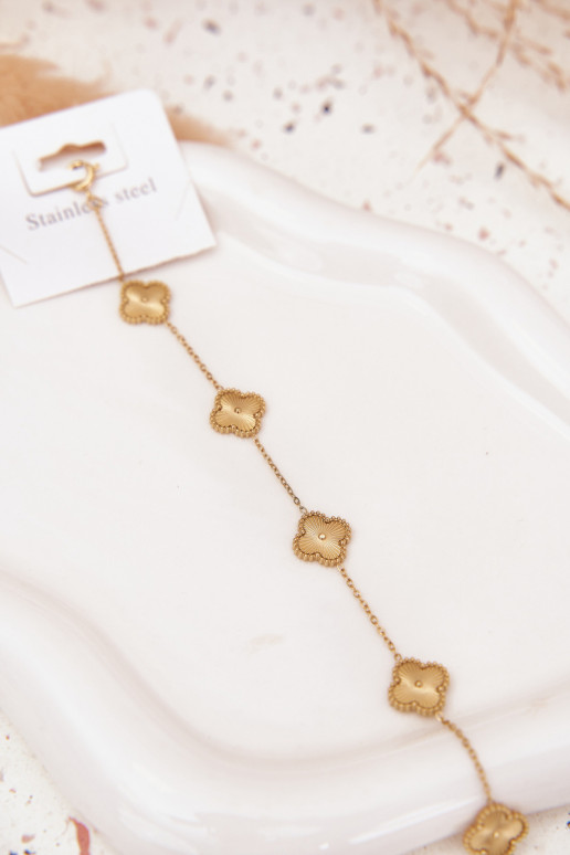 Un bracelet en acier inoxydableavec des motifs florauxuszkami couleur dorée