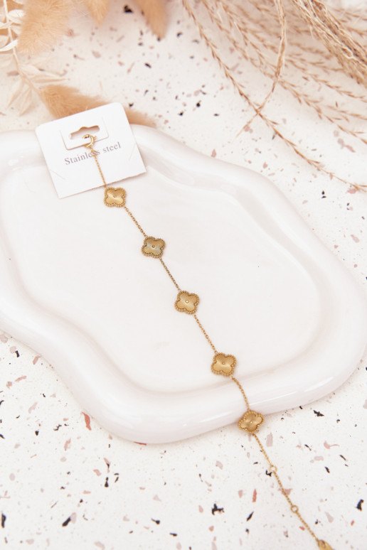 Un bracelet en acier inoxydableavec des motifs florauxuszkami couleur dorée