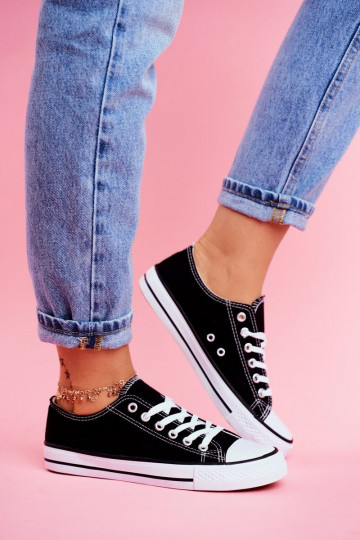 Chaussures décontractées modèle classique de couleur noire avec semelles blanches